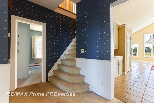10300 Lange Rd, Birch Run, MI 48415 - stairway featuring baseboard heating, tile patterned floors, vaulted ceiling, and wallpapered walls
