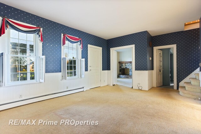10300 Lange Rd, Birch Run, MI 48415 - unfurnished room with wallpapered walls, a baseboard radiator, carpet, wainscoting, and stairs