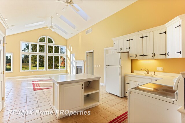 10300 Lange Rd, Birch Run, MI 48415 - kitchen with a ceiling fan, a sink, white appliances, high vaulted ceiling, and light tile patterned floors
