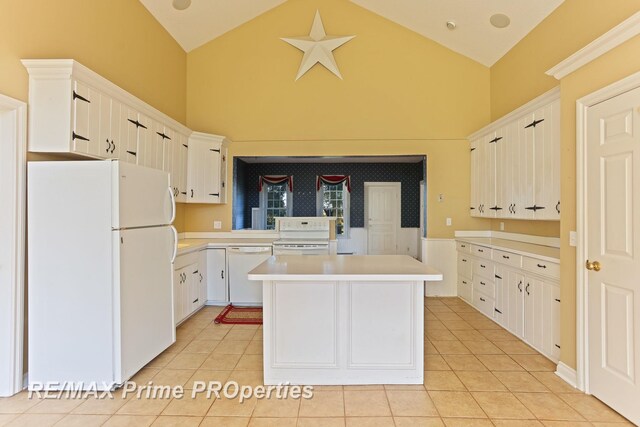 10300 Lange Rd, Birch Run, MI 48415 - kitchen with white appliances, high vaulted ceiling, light tile patterned flooring, a center island, and light countertops