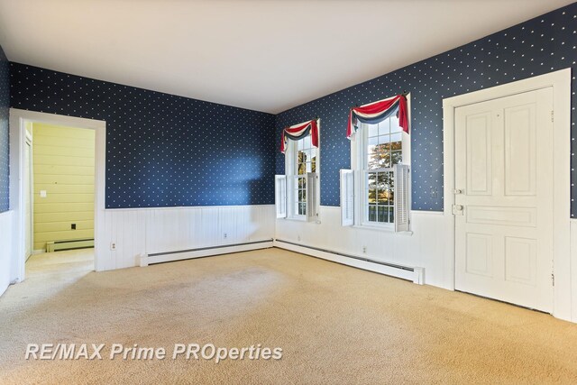 10300 Lange Rd, Birch Run, MI 48415 - empty room featuring carpet, wallpapered walls, wainscoting, and baseboard heating