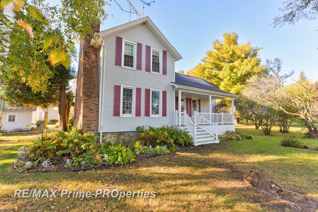 10300 Lange Rd, Birch Run, MI 48415 - view of front facade with a porch, a front lawn, and a chimney