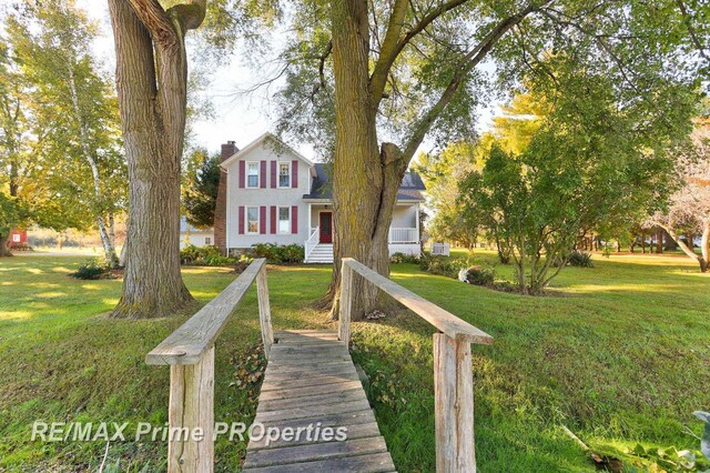 10300 Lange Rd, Birch Run, MI 48415 - view of front of home with a chimney and a front yard