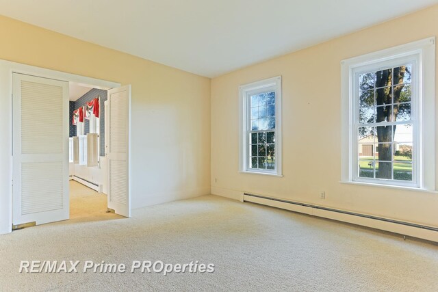 10300 Lange Rd, Birch Run, MI 48415 - empty room featuring a baseboard radiator, carpet floors, and healthy amount of natural light