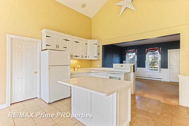 10300 Lange Rd, Birch Run, MI 48415 - kitchen with white appliances, a baseboard heating unit, light countertops, a sink, and light tile patterned floors