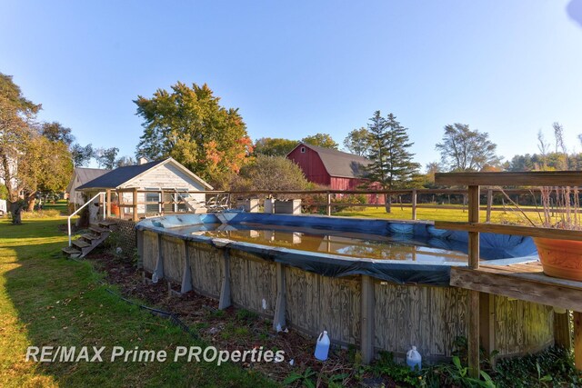 10300 Lange Rd, Birch Run, MI 48415 - view of pool with a yard, a covered pool, and a wooden deck
