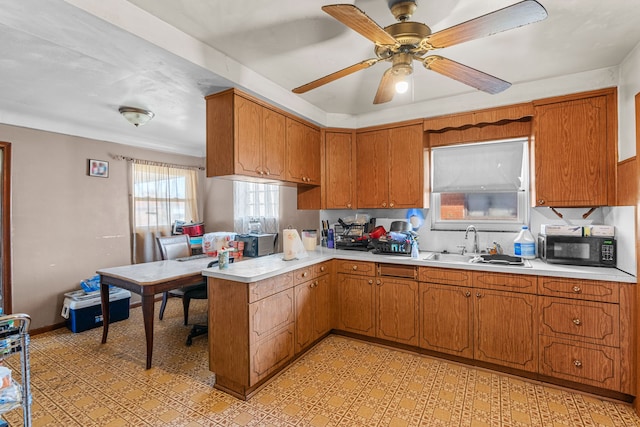 kitchen featuring ceiling fan and sink