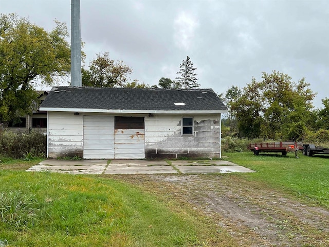 view of outbuilding featuring a lawn