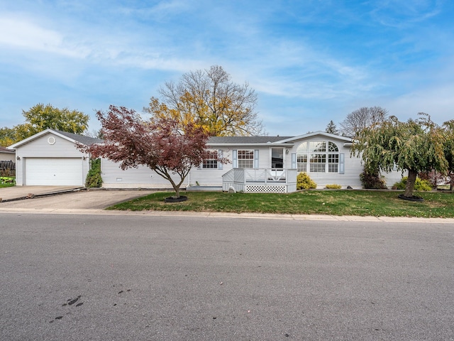 ranch-style house with a garage and a front lawn