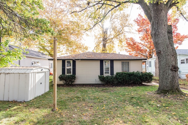 view of front of house featuring a front yard and a shed