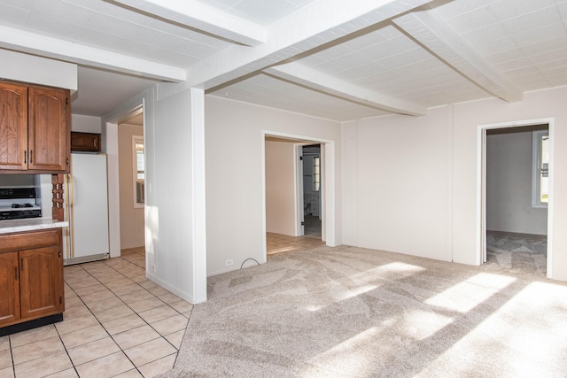 interior space featuring beamed ceiling and light carpet