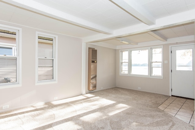 carpeted spare room with beam ceiling