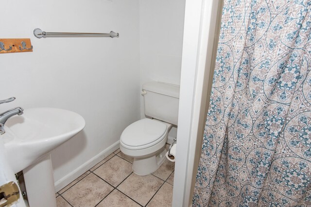 bathroom featuring tile patterned flooring, sink, and toilet