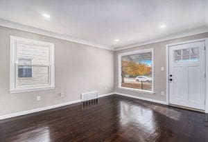 foyer with dark hardwood / wood-style flooring and ornamental molding