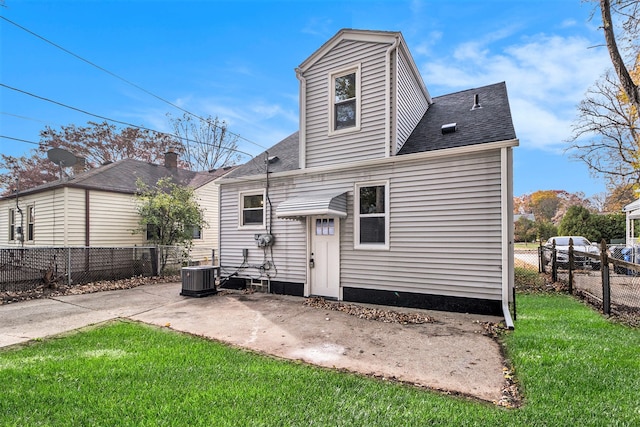 rear view of house with a patio area, a yard, and central air condition unit