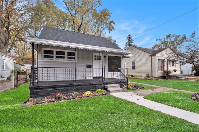 bungalow-style house with covered porch and a front yard