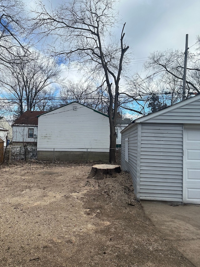 view of side of property featuring an outbuilding and a garage