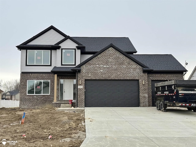 view of front of house with concrete driveway, brick siding, an attached garage, and a shingled roof