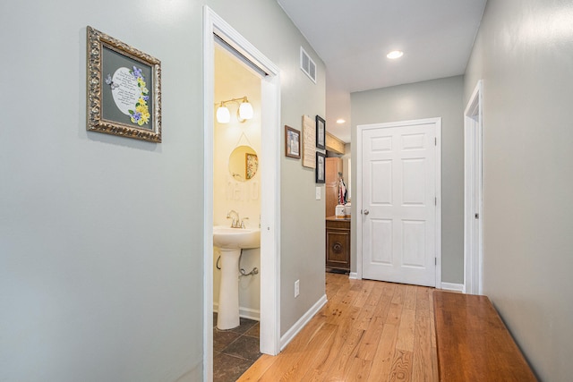 corridor featuring light hardwood / wood-style floors