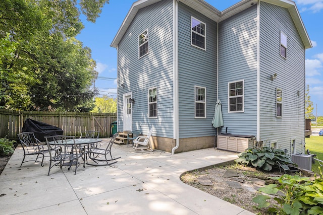 back of house featuring central AC unit and a patio