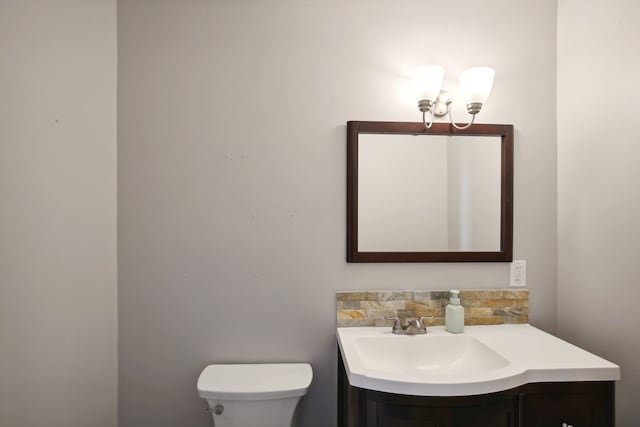 bathroom with toilet and vanity