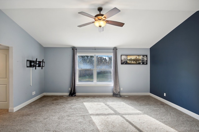 unfurnished room featuring baseboards, carpet, and lofted ceiling