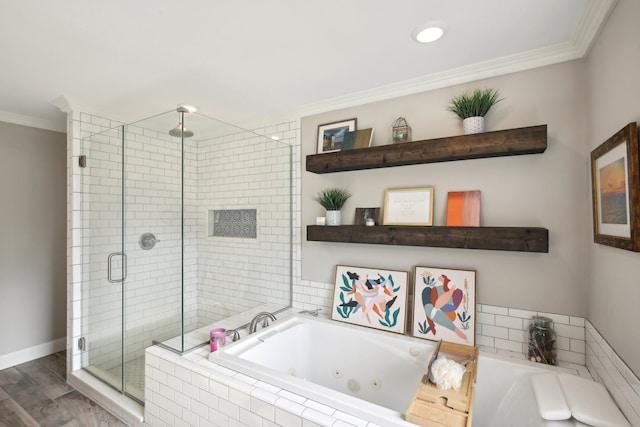 full bath with ornamental molding, wood finished floors, a tub with jets, a shower stall, and baseboards