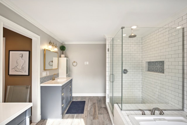 bathroom with crown molding, baseboards, a stall shower, wood finished floors, and vanity