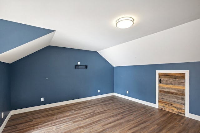 bonus room with baseboards, lofted ceiling, and wood finished floors