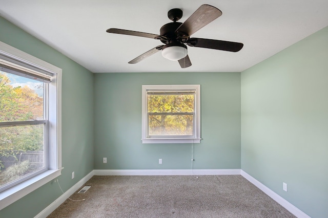 spare room with visible vents, baseboards, and carpet