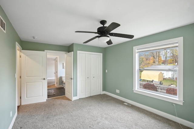 unfurnished bedroom featuring visible vents, baseboards, carpet, a closet, and a ceiling fan