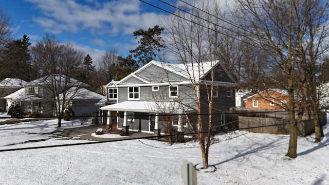 snow covered property featuring fence