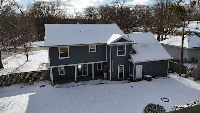 snow covered property featuring fence