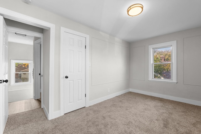 unfurnished bedroom featuring light carpet