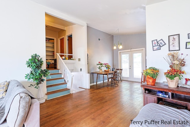 foyer entrance with french doors, an inviting chandelier, and hardwood / wood-style floors