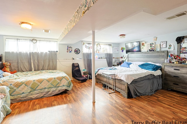 bedroom with wood-type flooring