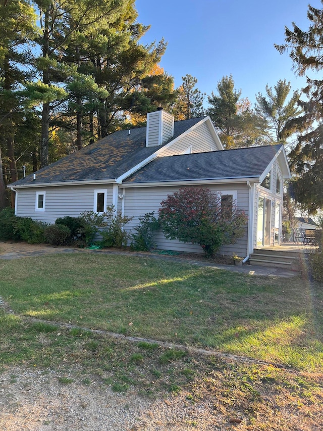 view of side of home featuring a yard