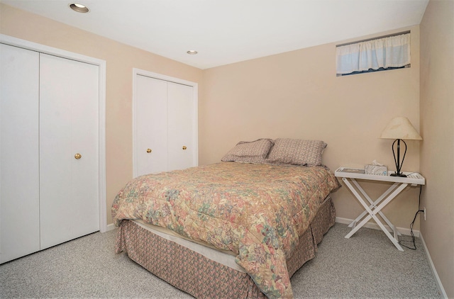 carpeted bedroom featuring multiple closets