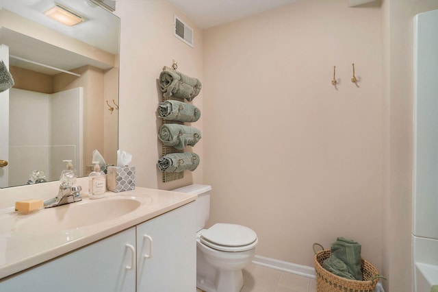 bathroom featuring tile patterned floors, vanity, toilet, and walk in shower