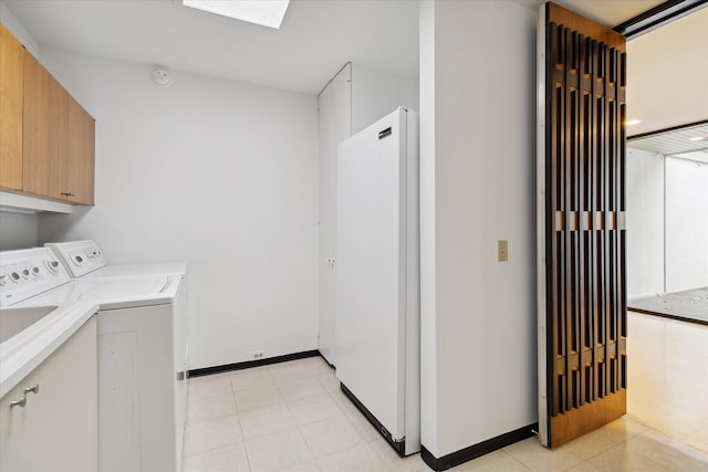 laundry room featuring cabinets and washing machine and dryer