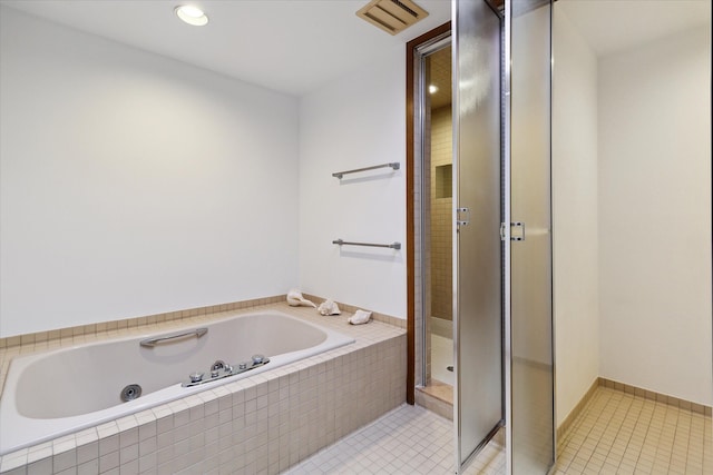 bathroom featuring tile patterned flooring and shower with separate bathtub