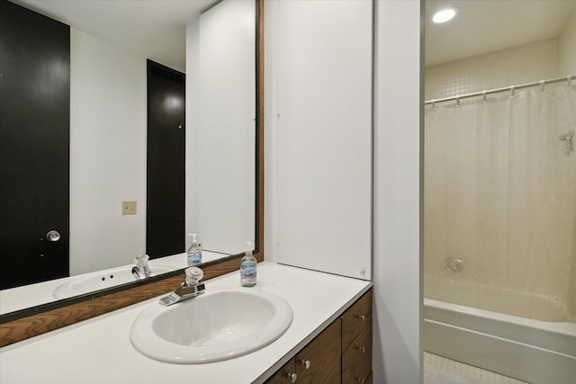 bathroom featuring vanity and shower / bath combination with curtain