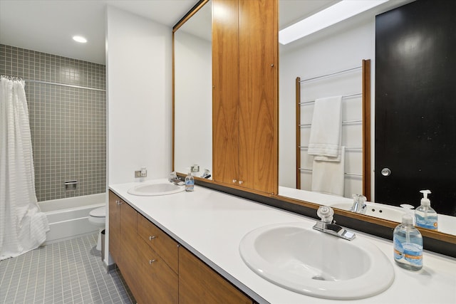 full bathroom featuring tile patterned flooring, vanity, shower / bath combo, and toilet