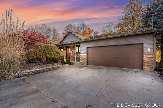 2766 48th Ave, Zeeland, MI 49464 - view of front of house with stone siding, driveway, and an attached garage
