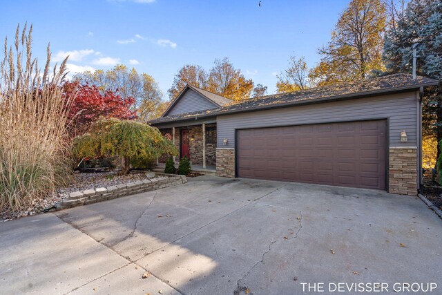 2766 48th Ave, Zeeland, MI 49464 - view of front of property with stone siding, driveway, and a garage