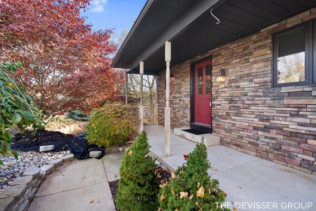 2766 48th Ave, Zeeland, MI 49464 - view of exterior entry featuring stone siding and covered porch
