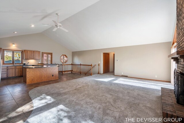 2766 48th Ave, Zeeland, MI 49464 - unfurnished living room featuring ceiling fan, a fireplace, and high vaulted ceiling