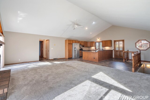 2766 48th Ave, Zeeland, MI 49464 - unfurnished living room featuring ceiling fan, dark colored carpet, high vaulted ceiling, and baseboards