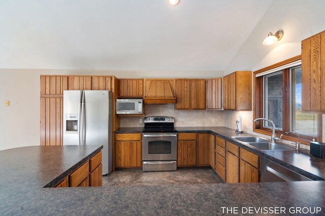 2766 48th Ave, Zeeland, MI 49464 - kitchen with stainless steel appliances, a sink, lofted ceiling, backsplash, and brown cabinets
