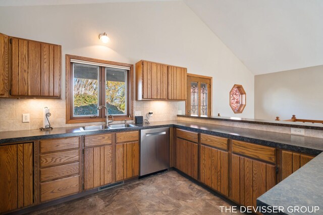 2766 48th Ave, Zeeland, MI 49464 - kitchen featuring dishwasher, a sink, dark countertops, brown cabinets, and high vaulted ceiling